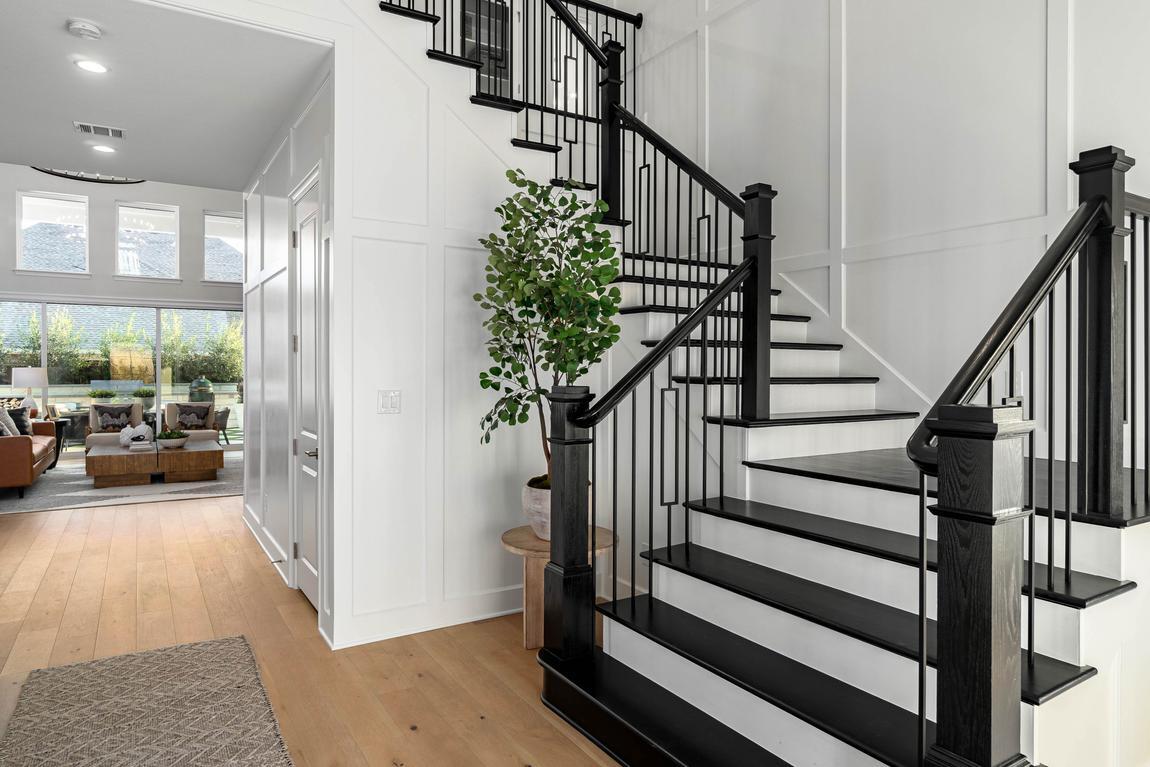 Elegant staircase with black metal railings and white risers