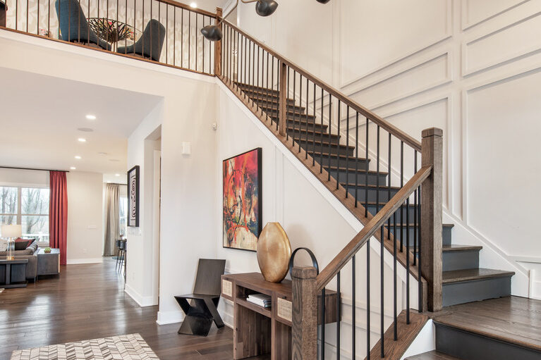 Stunning foyer with dual floating staircases and chandelier