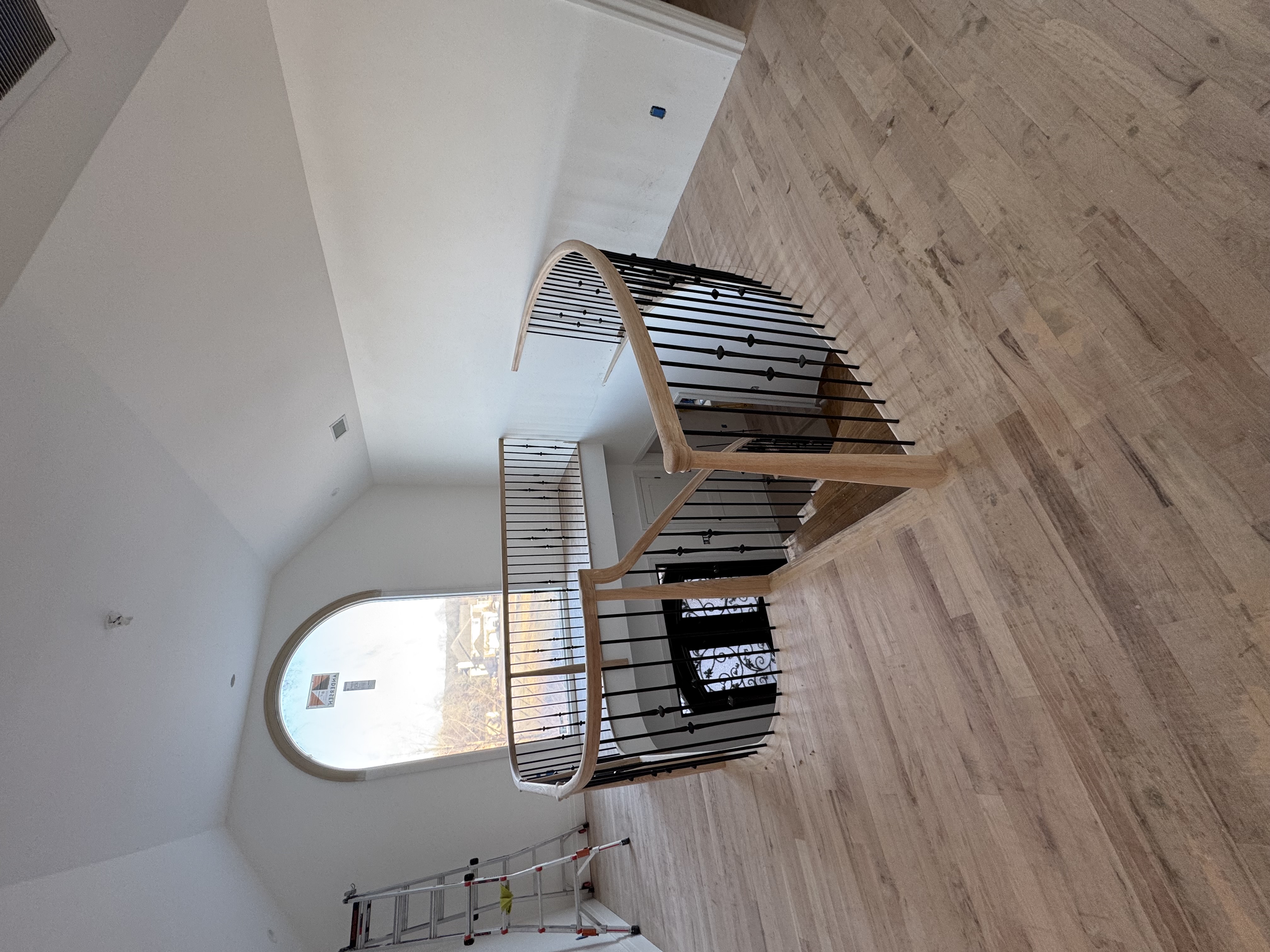 Elegant curved staircase with horizontal railings