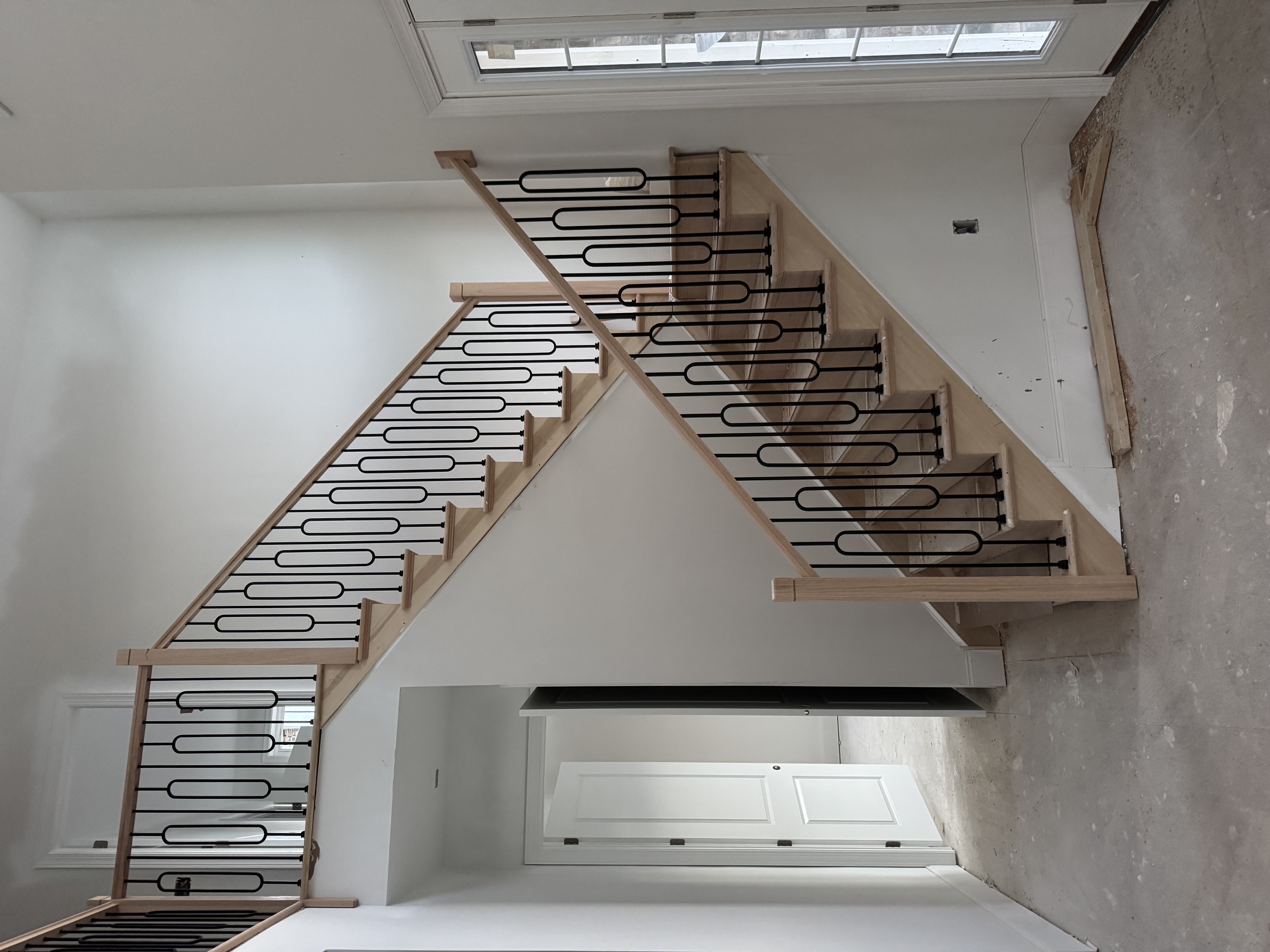 Custom wooden staircase with modern black metal railings